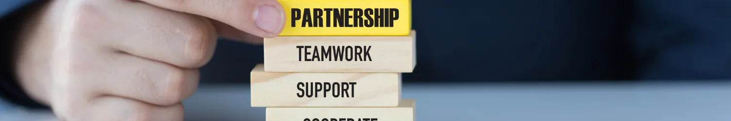 Stack of blocks highlighting the word partnership.