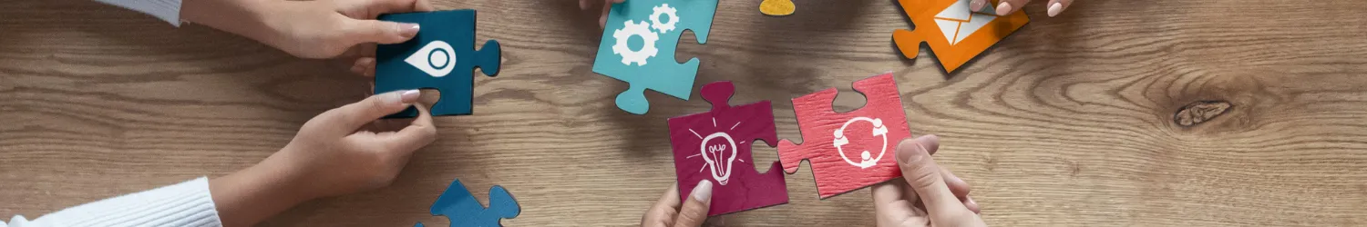 A group of people putting puzzle pieces together.